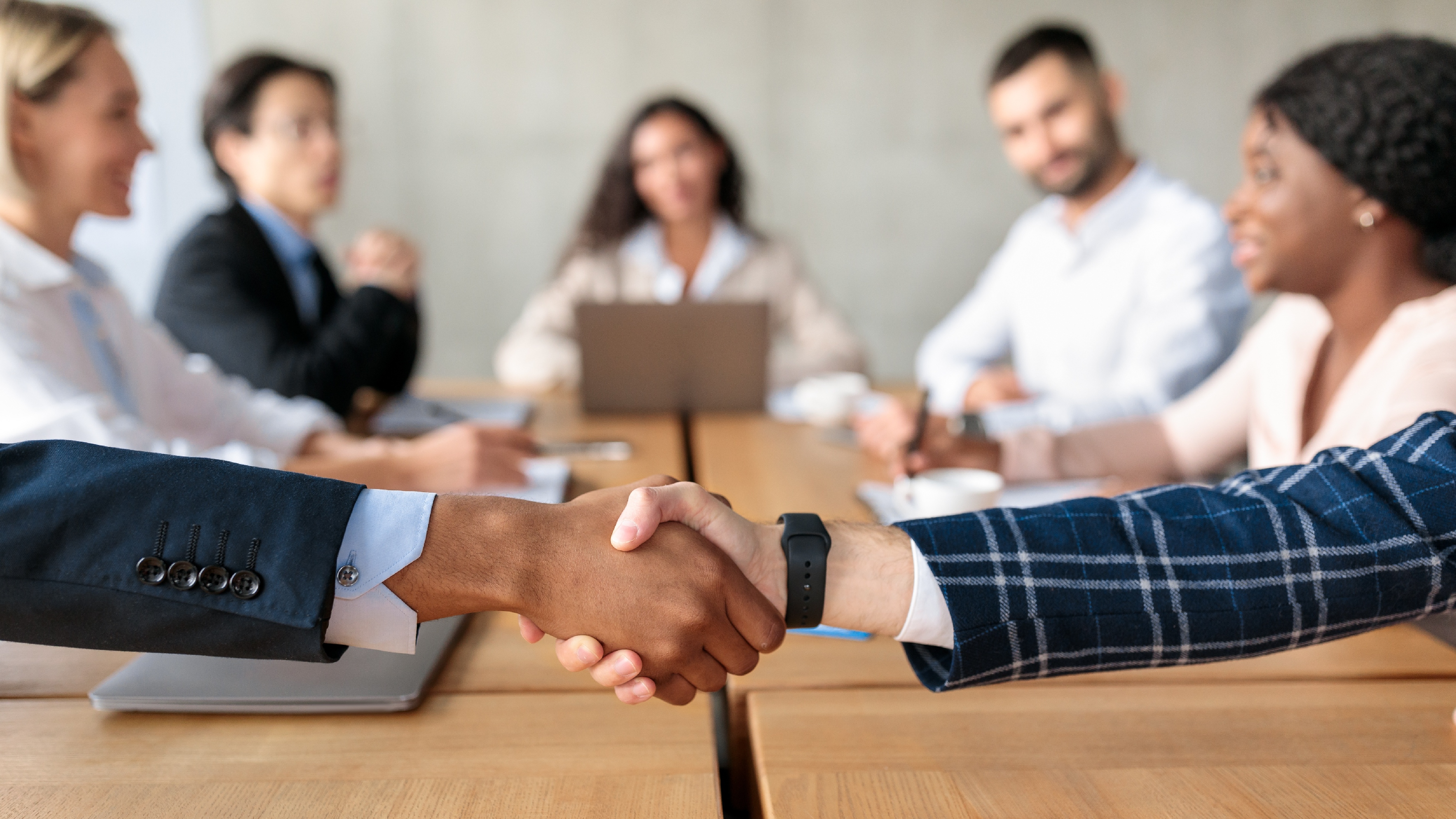 closeup-of-handshake-greeting-at-corporate-meeting-2022-12-16-08-09-41-utc-1-1